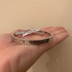 I Purchased The Bracelet And It Is Lovely! It Is Brand New! I Purchased It For $80, It Was Originally Priced At $88. It Has A Clasp That Does Not Allow For The Bracket To Fall Off And Has Beautiful Details On The Side Of The Bracelet. It Is A Beautiful Piece To Add To A Coach Lovers Collection! Modern Coach Jewelry For Formal Occasions, Coach Adjustable Bangle, Adjustable Coach Bangle, Coach Metal Bracelet Jewelry, Coach Metal Bangle Jewelry, Classic Coach Bangle Jewelry, Coach Bracelets As Gift, Coach Classic Bangle Jewelry, Coach Formal Bracelet Jewelry