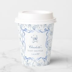 a blue and white baby shower cup on a marble surface