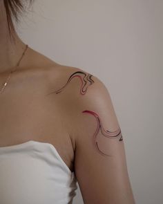 a woman with a tattoo on her shoulder