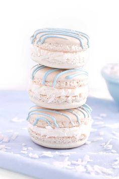 three cookies stacked on top of each other with blue and white frosting around them