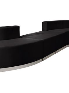 a black couch sitting on top of a white floor