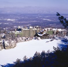 an aerial view of a resort in the winter with snow on the ground and trees