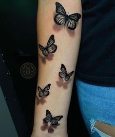 a woman's arm with butterflies on it