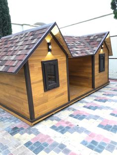 a dog house made out of wood and shingles