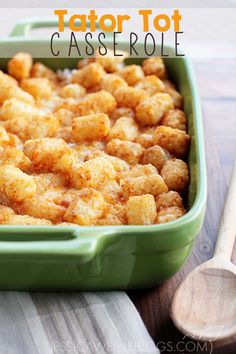 tater tot casserole in a green dish with spoons on the side