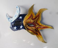 a mask that has been painted to look like the moon and stars are on it