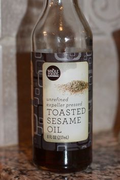 a bottle of toasted sesame oil sitting on a counter