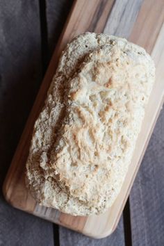 a loaf of bread sitting on top of a wooden cutting board