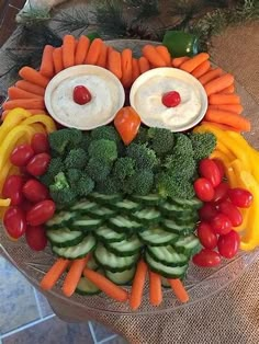 an owl made out of veggies and carrots on a glass platter