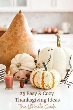 a table topped with lots of white pumpkins and other fall decorating items on top of it