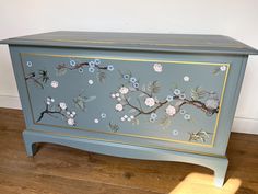 a painted chest with flowers and birds on it