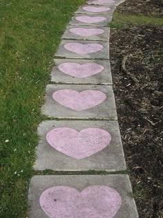 cement walkway with painted hearts and the word genivi written on it