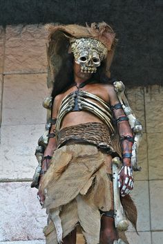 a woman dressed up in costume and headdress