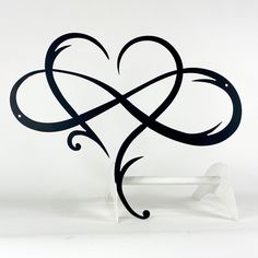 a heart shaped sculpture sitting on top of a white bench