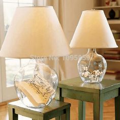 two lamps sitting on top of wooden tables next to each other