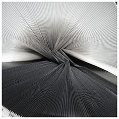 an abstract black and white photo with pleated fabric