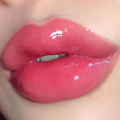 a close up shot of a woman's lips with bright pink liquid on them