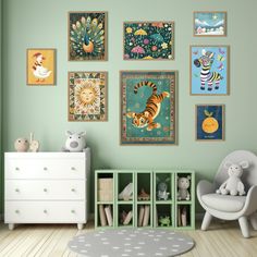 a child's room with green walls and pictures on the wall