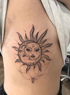 a woman with a sun tattoo on her stomach