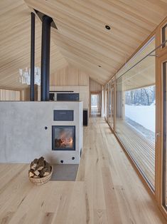 the interior of a house with wood flooring and walls, along with a fireplace