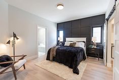 a bedroom with white and black decor in it