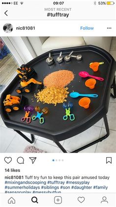 a tray with scissors and other toys on it, sitting on top of a table