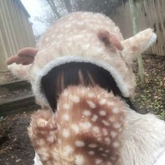 a close up of a person wearing a deer hat