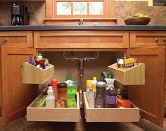 an open drawer in a kitchen filled with cleaning products