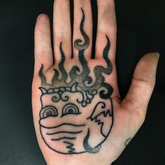 a person's hand with a tattoo on it