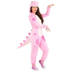 a woman in a pink dinosaur costume posing for the camera with her hand out and pointing