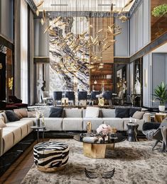 a living room filled with furniture and a chandelier hanging over the top of it