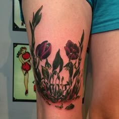 a woman's thigh with flowers on it