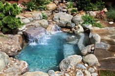 a small pond with rocks and water running through it