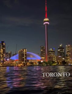 the toronto skyline is lit up at night