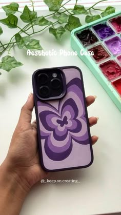 a person holding an iphone case in front of a box of ice cubes and flowers