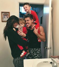 a family taking a selfie in the bathroom