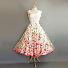 a white dress with pink flowers on it