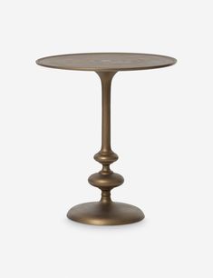 a small round table with two pedestals on the top and one leg in bronze