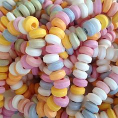 there are many different colored candy beads together