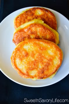 three fried eggs on a white plate