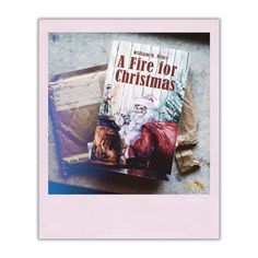 a fire for christmas book sitting on top of a table next to some paper bags