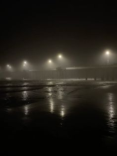 foggy night at the beach with street lights