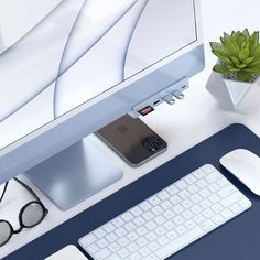 an apple computer sitting on top of a desk next to a keyboard and mouse,