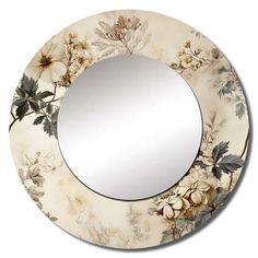 a round mirror with flowers painted on the front and sides, hanging from a wall