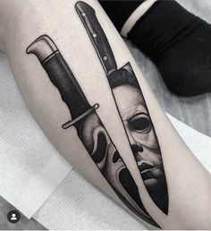 a tattoo with two knives and a mask on it