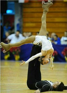 two young women doing acrobatic tricks on the floor