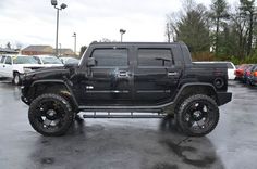 a black hummer truck parked in a parking lot