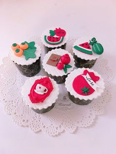 cupcakes decorated with different designs on a doily