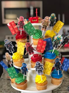 cupcakes decorated with lego blocks and star wars characters on a cake platter