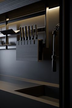 a kitchen sink and faucet in front of a wall mounted shelf with utensils hanging from it